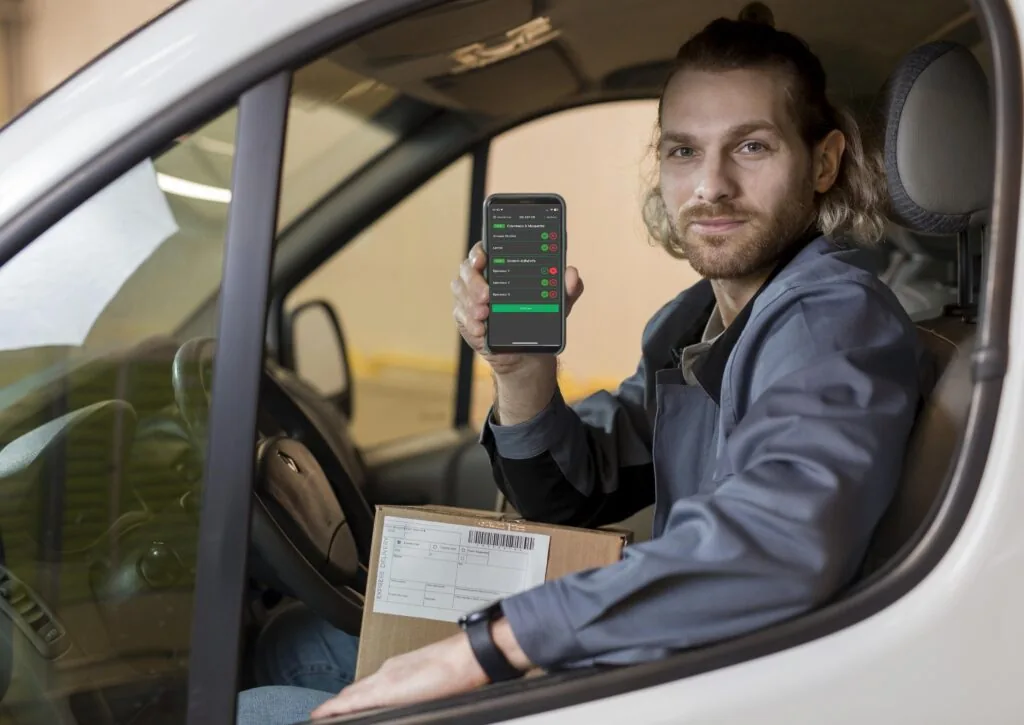 Conducteur tenant un smartphone avec l'application d'inspection véhicule